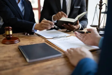 Lawyer with various documents at desk