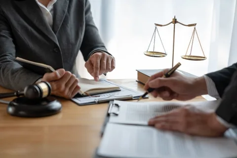 Lawyer with various documents at desk